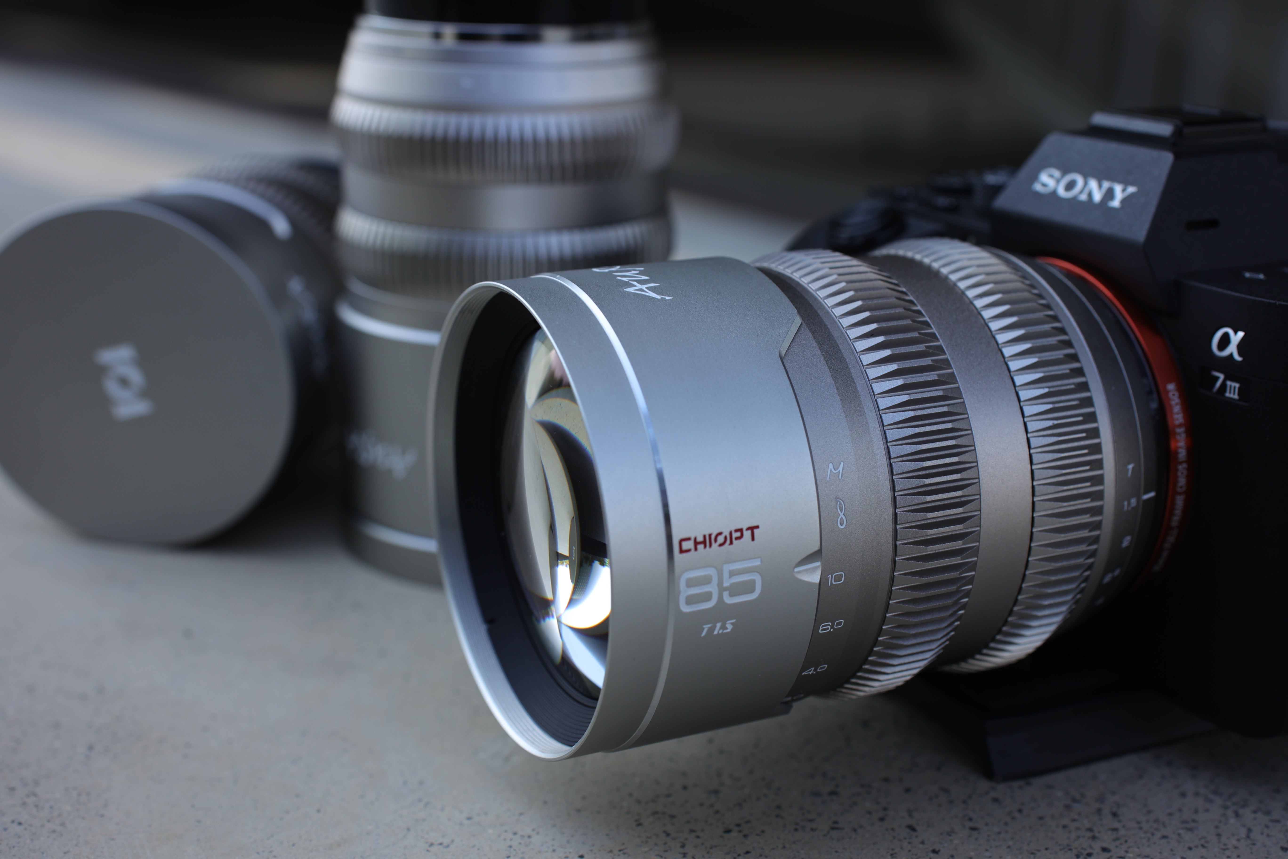 Chiopt Aura Super Speed prime cine lens lifestyle set, including 16mm, 24mm, 35mm, 50mm, and 85mm focal lengths, professional manual focus cinema lenses for filmmaking and versatile video production.