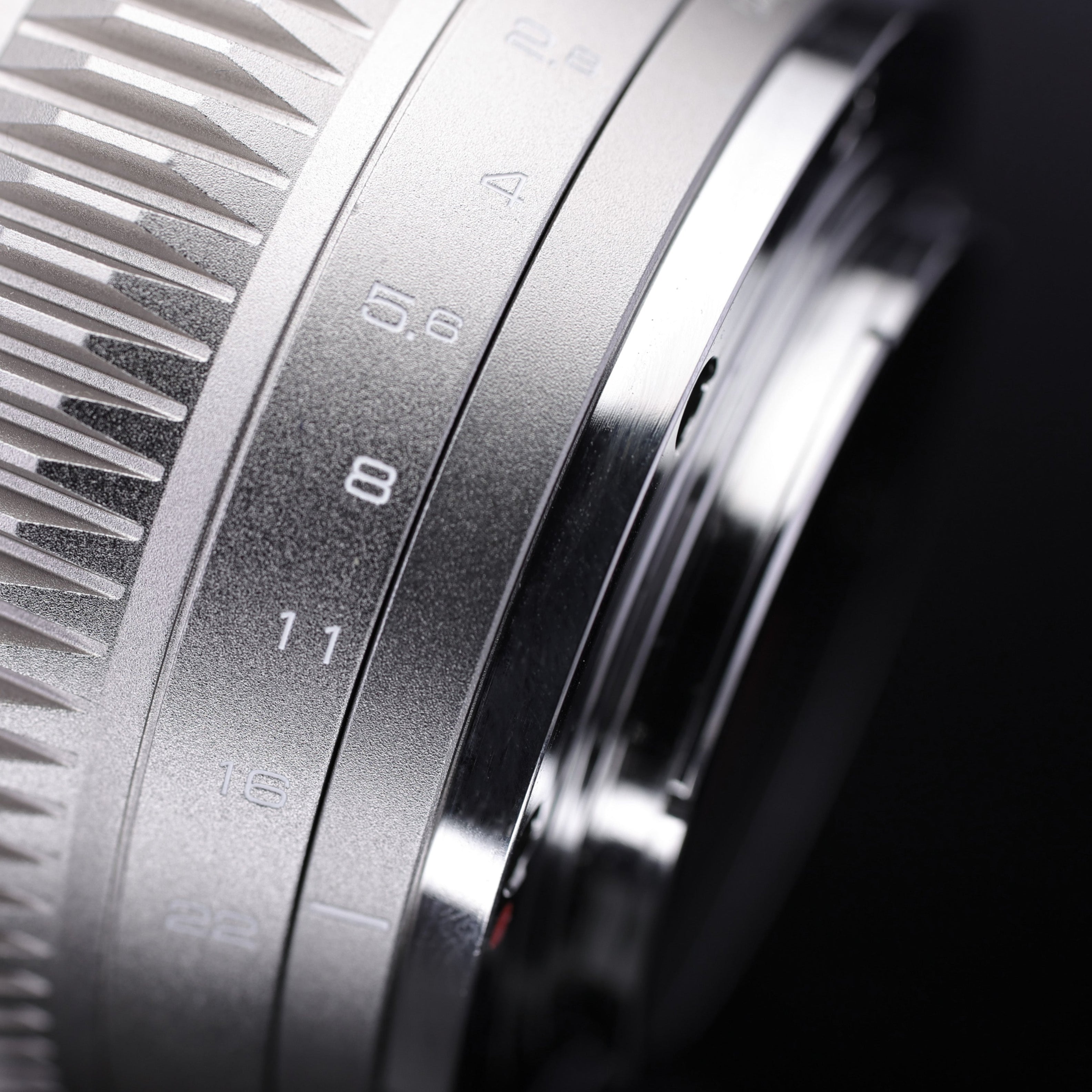 Detailed view of Chiopt Aura lens with laser-etched scale markings for accurate focus and aperture control