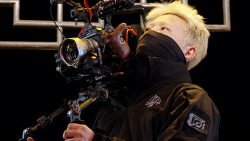 Chiopt Aura cine lens mounted on shoulder rig for narrative or documentary production