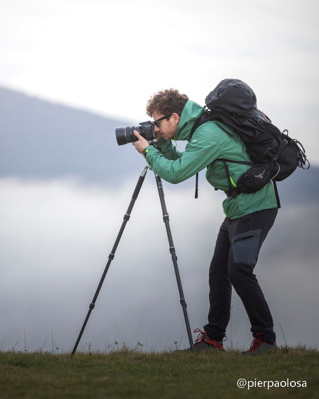 Professional all-weather carbon fiber tripod fully extended, designed for reliable use in harsh winter conditions including snowstorms, ice, and freezing winds.