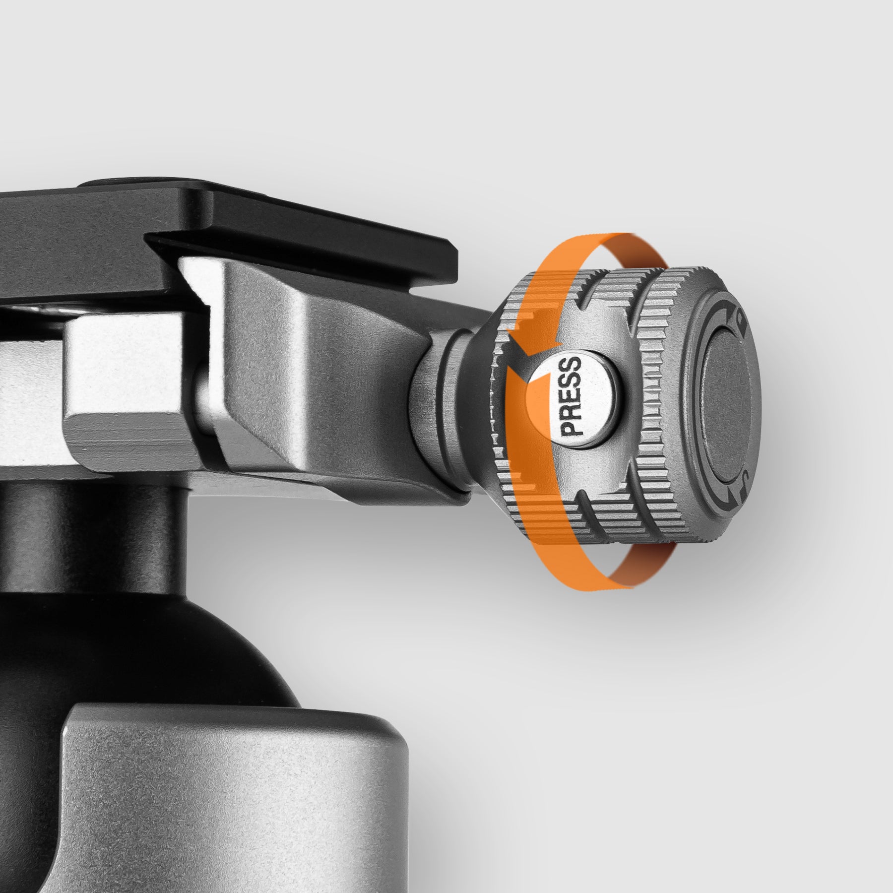 Close-up view of Fotopro T-ROC tripod quick-release knob with patented safety lock system, showing two-step press-and-turn operation to prevent accidental camera drops.
