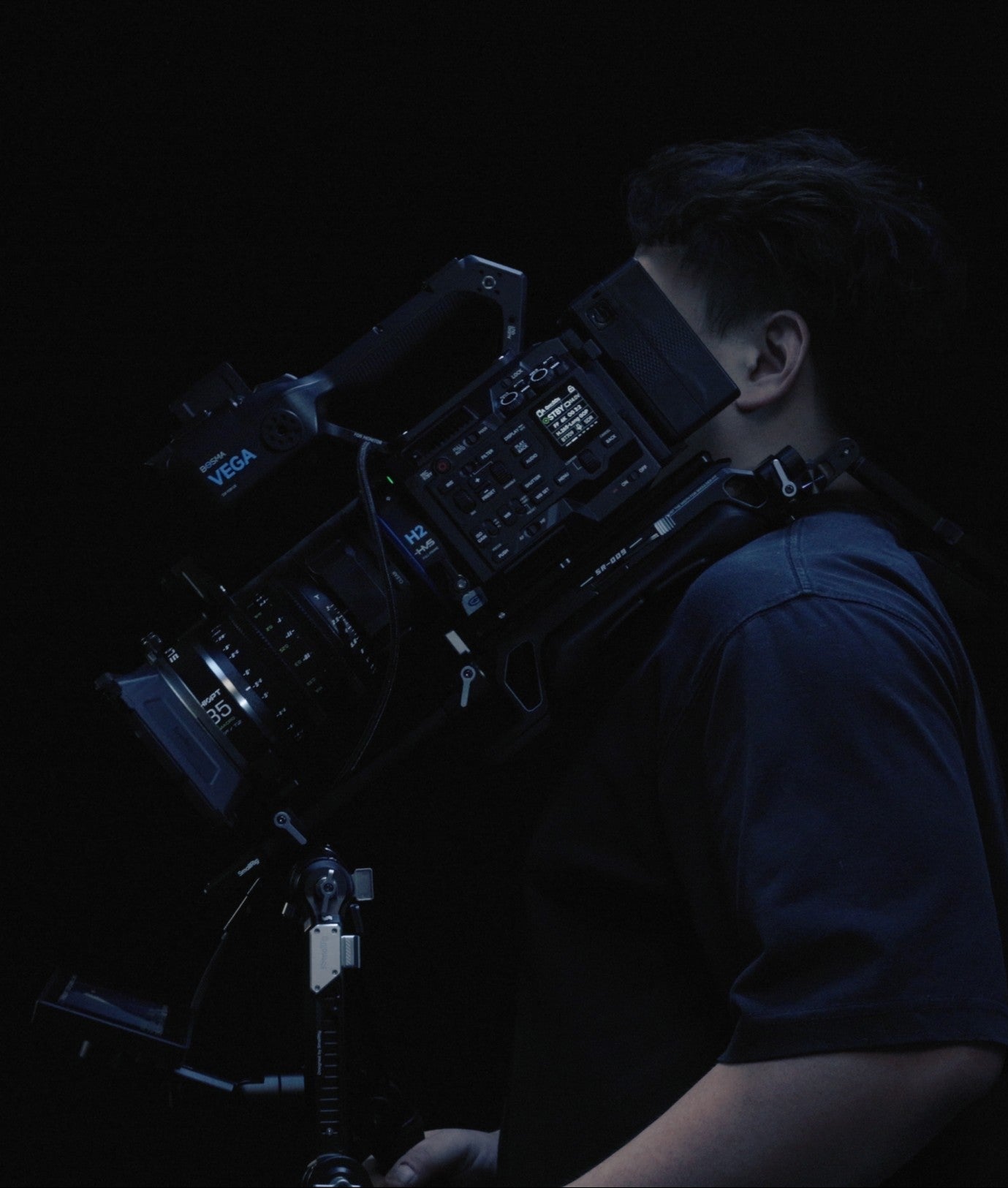 BOSMA VEGA H2 full frame cinema camera delivering high-resolution 6K video and cinematic image quality, with PL, EF and M mount compatibility, H.264 and H.265 recording, ALL-Intra codec support and advanced autofocus technology. A person easily holding a large set of Bosma Vega H2 camera with Chiopt slasher 35mm prime lens equipment for filmmaking.