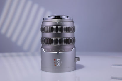 Chiopt Aura 24mm T1.5 cinema prime lens, wide-angle cine lens for 8K camera, professional filmmaking, low-light video shooting, and cinematic wide shots with excellent clarity and color accuracy.