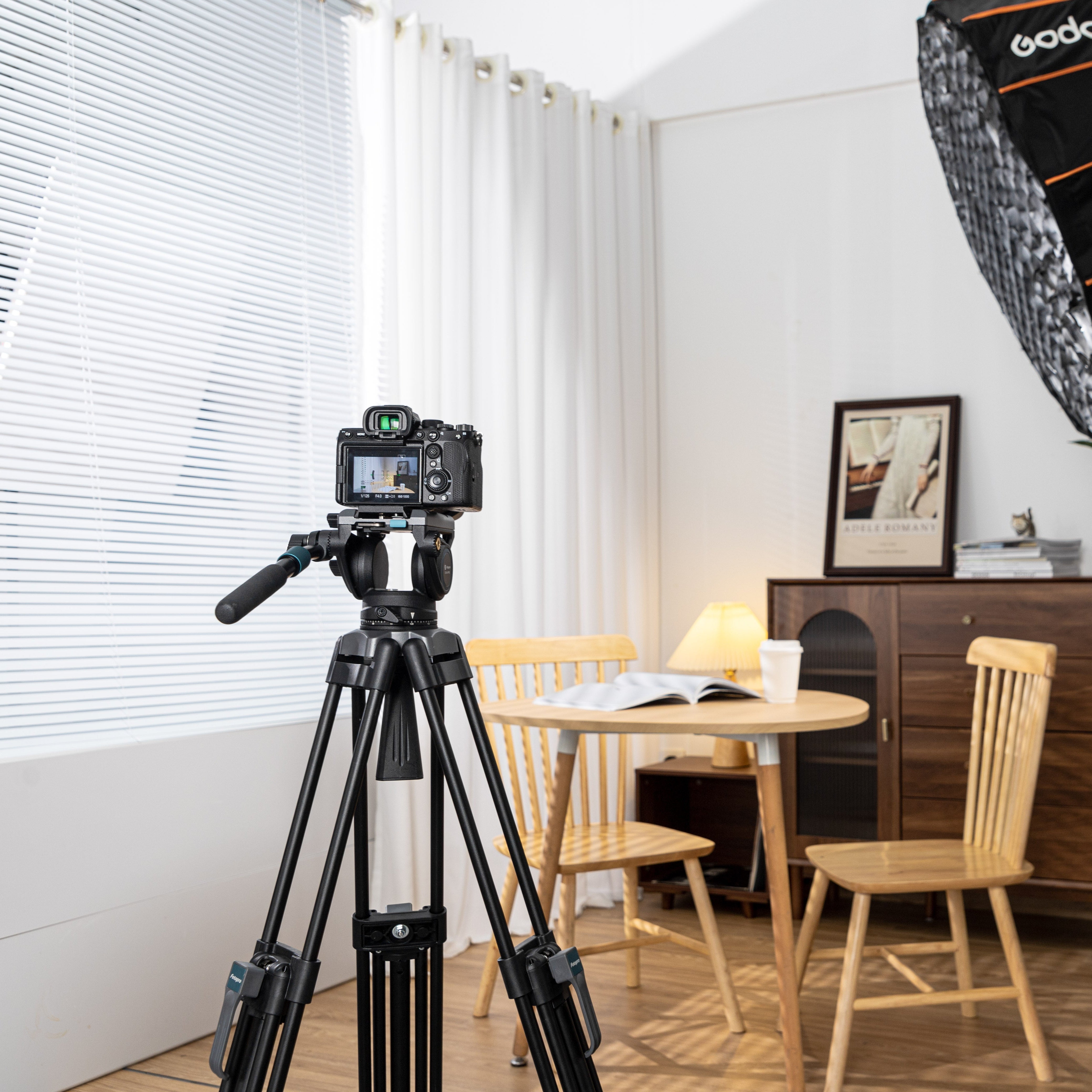 Fotopro DV-3A Pro fluid video tripod in indoor shooting scene, ideal for studio video recording, product filming, interviews, and live streaming. Smooth pan and tilt, stable support, and professional-grade design for filmmakers and content creators.