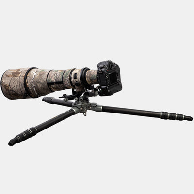 Fotopro E7 heavy-duty tripod fully extended for low-angle shooting, legs spread almost flat for ground-level photography, ideal for macro, wildlife, and bird photography in uneven or rugged terrain.