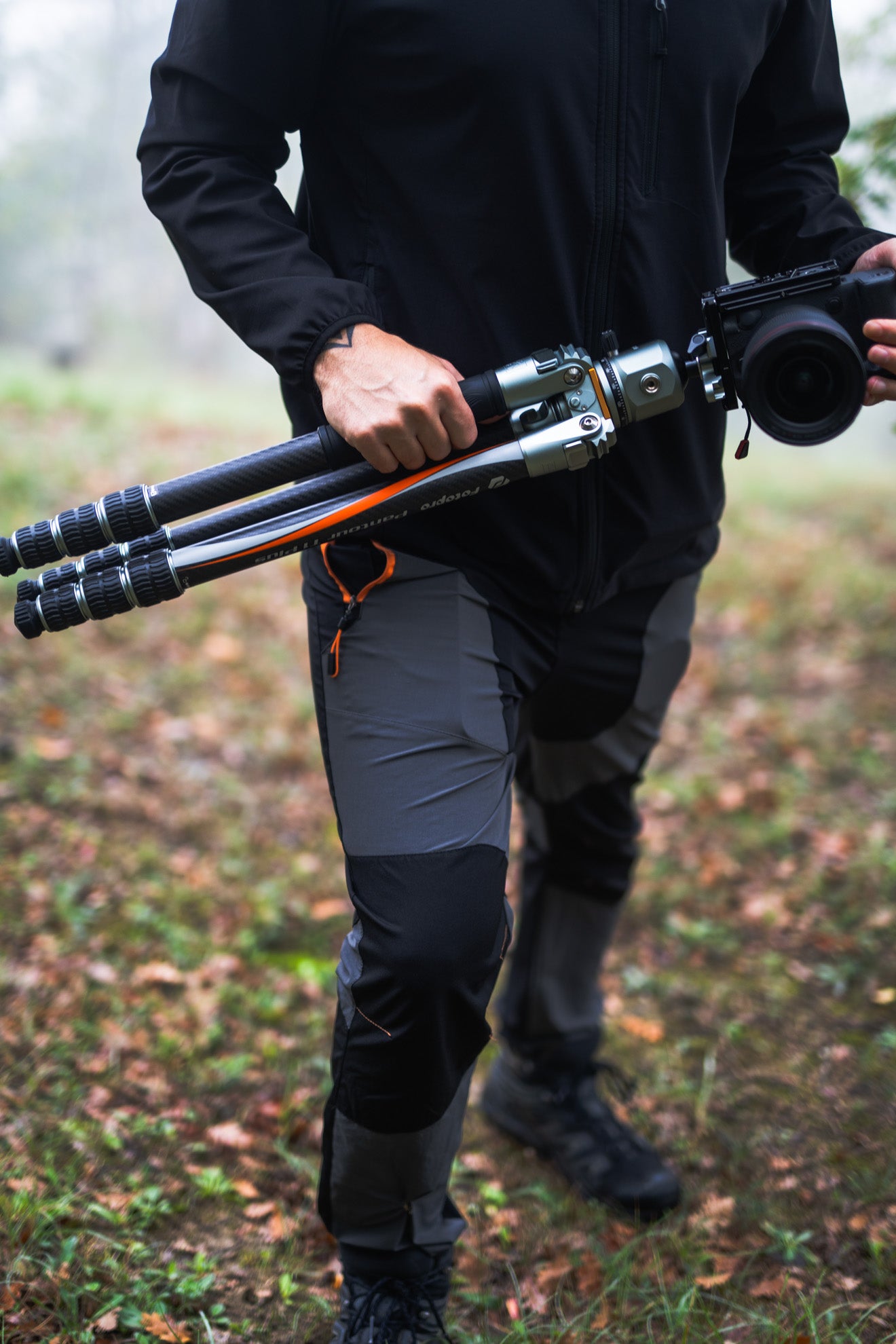 Hand holding Fotopro professional camera tripod t1 plus, showcasing sleek design, sturdy build, and precision engineering for photographers and videographers.