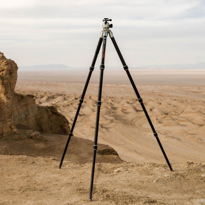 Fotopro T1 Plus carbon fiber tripod lifestyle shot in desert, dustproof, waterproof, weather-resistant, ideal for travel, outdoor, and extreme terrain photography.
