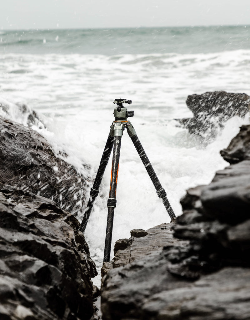 Fotopro T1 Plus camera tripod in beach, seaside, and shallow water settings. Waterproof, corrosion-resistant, and stable on sand and wet ground, perfect for coastal photography, seascapes, and long exposure shots.